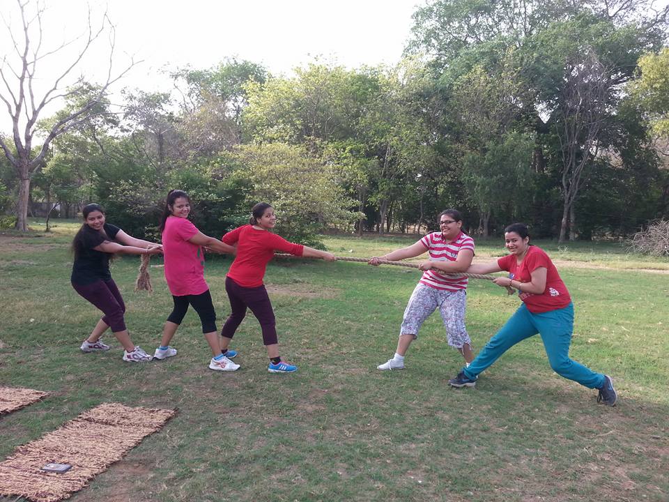 A circuit training session featuring various exercise stations and participants.